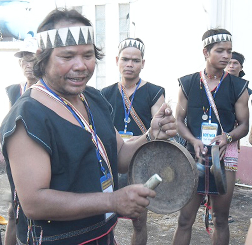 Nghệ nhân Đinh Xuân (bìa trái) ôn lại các bài chiêng trước khi trình diễn. Ảnh: A.D ảnh 1 Nghệ nhân Đinh Xuân (bìa trái) ôn lại các bài chiêng trước khi trình diễn. Ảnh: A.D ảnh 1